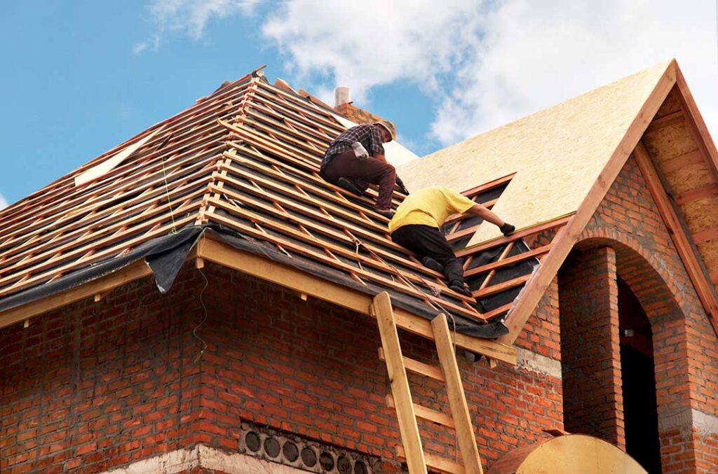Attic airflow channels beneath roof sheathing with soffit vents, insulation, and a ridge vent visible.