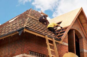 Attic airflow channels beneath roof sheathing with soffit vents, insulation, and a ridge vent visible.